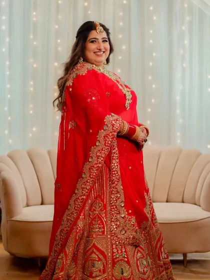 This bride is ready for her reception party. The lighting catches the beautiful glow on her skin, a result of careful highlighting and a dewy base.