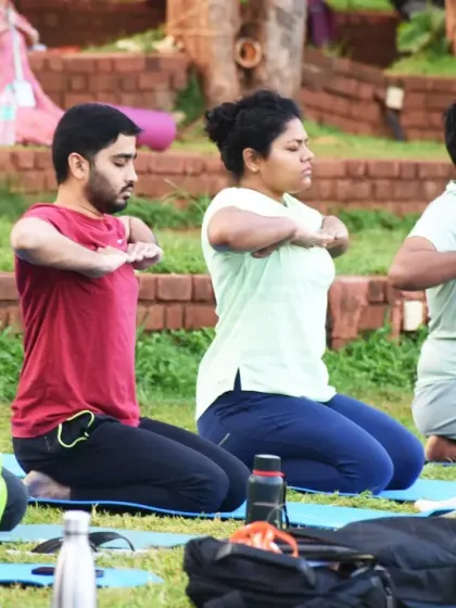 Participants practicing a kneeling yoga posture together. The spirit of Seva, or service, is woven into our community life, and volunteering is a powerful path to personal growth and connection.