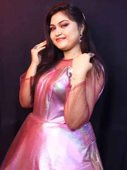 This metallic pink gown is a true party starter. The iridescent fabric catches the light beautifully, making it a perfect choice for evening events, fashion shows, or a glamorous birthday shoot.