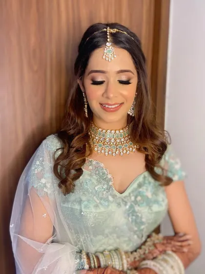 This shot showcases the delicate shimmer on Aashna's eyelids, which catches the light beautifully and adds a touch of magic to her wedding makeup.
