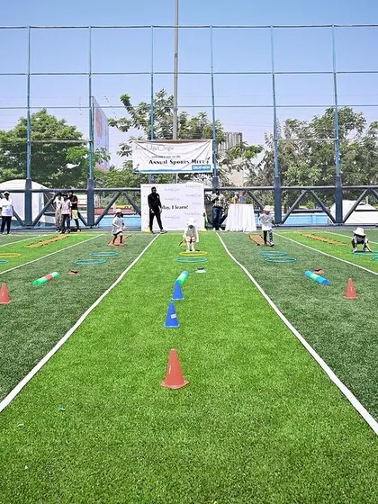 A wide shot of the obstacle course at our Annual Sports Meet, filled with children running and playing.