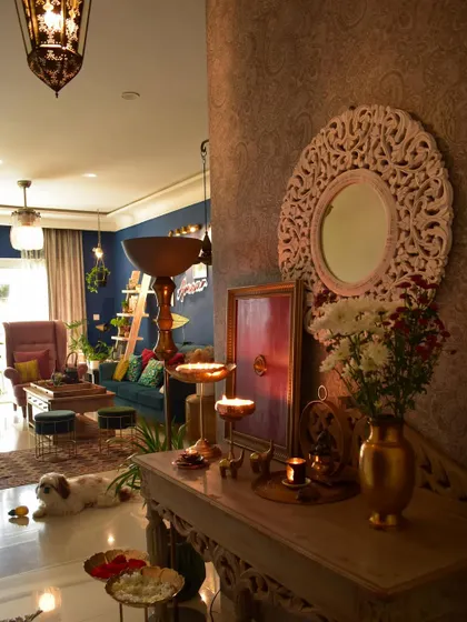A festive and traditional look for the entryway, with diyas, flowers, and my furry supervisor making sure everything is perfect.