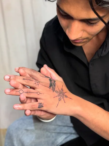 The client admiring his new hand tattoo.