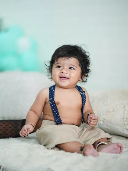 A happy 6-month-old showing off his sitting skills.