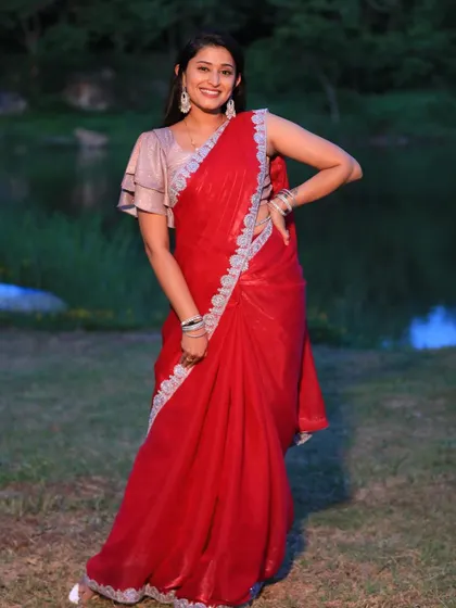 The vibrant red of this saree makes it a standout piece for any celebration.