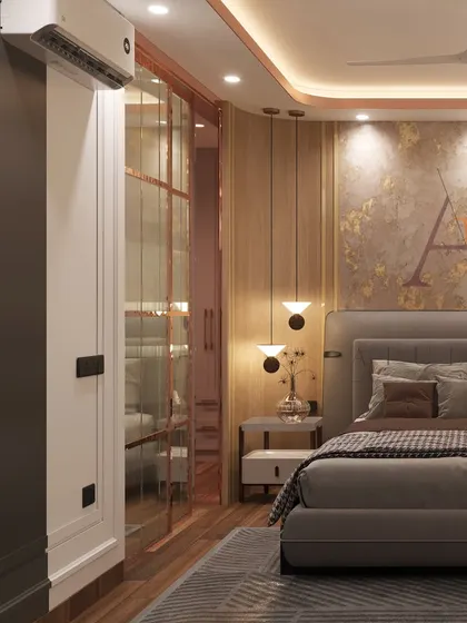 A modern luxury bedroom from a Sobha City project, featuring a textured gold-leaf accent wall, wooden paneling, and elegant pendant lights.