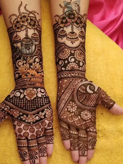 This design features hanging jhumkas, butterflies, and a peacock, creating a whimsical and festive look.