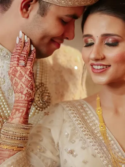 A tender moment between the bride and groom. The bride's hand gently on his cheek, capturing the love and affection on their wedding day.