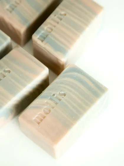 This bar is colored naturally with kaolin clay, indigo powder, and French pink clay, with a striking line design that looks like a sunset in motion.