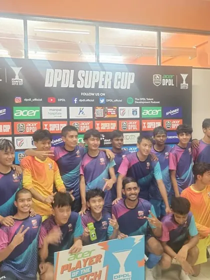 The team celebrating with their Player of the Match after qualifying for the Super Six.