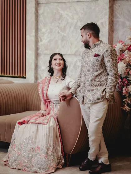 A posed but relaxed portrait of the couple. I guide my clients into natural poses that reflect their connection, like this one on a modern sofa.
