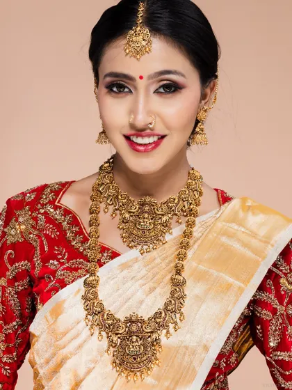 A classic South Indian bridal portrait, featuring a model in a traditional red and white saree with elaborate gold temple jewellery. My studio is equipped to handle all types of traditional wear shoots.