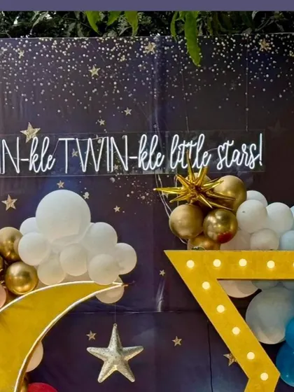 The neon sign "TWIN-kle TWIN-kle little stars!" against the starry night backdrop, serving as a perfect centerpiece for the theme.