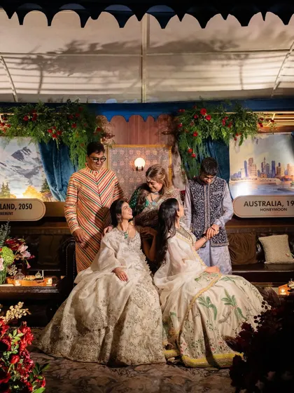 A beautiful family portrait taken within one of the custom-built train lounges. The destination signs in the background represent significant places in the family's journey.