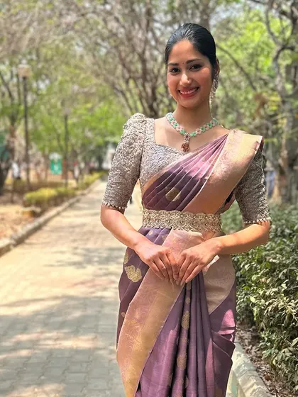 A beautiful shot of a model wearing a hand-embellished blouse, perfectly styled with a Kanchipuram saree for an engagement look.
