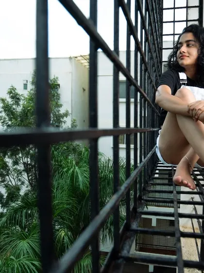 A candid shot of the model relaxing on a balcony. This kind of image feels authentic and tells a small story.