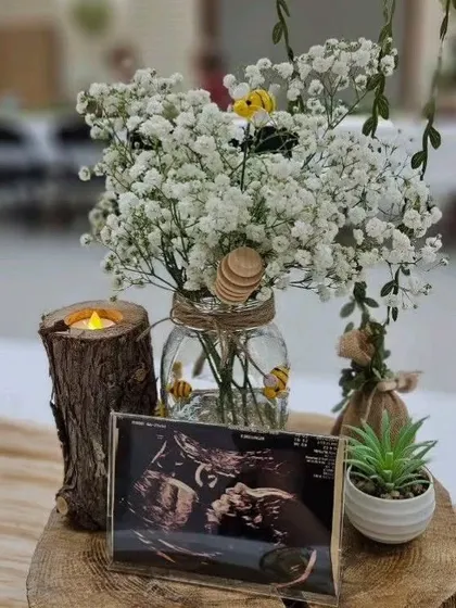 It's the small details that make an event special. For this baby shower, I created a rustic centerpiece featuring the baby's sonogram, making the celebration deeply personal and heartwarming.