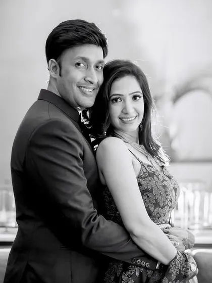 An elegant, classic couple portrait in black and white. The soft lighting and their happy expressions make for a timeless engagement photo.