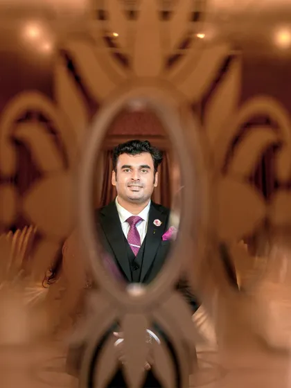 A handsome portrait of the groom, framed perfectly by the decorative glass.