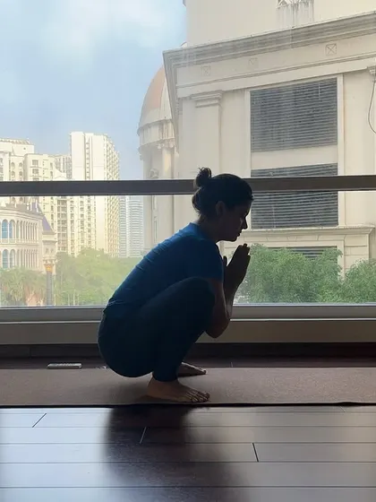 At Svādhyāya, we embrace the journey over the destination. A student finds her balance and focus in Malasana (Garland Pose).