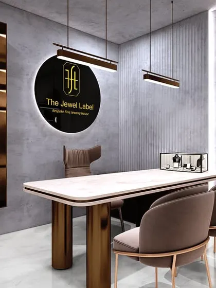The private consultation area in the jewelry studio, featuring the brand logo and elegant display cases. The design provides a quiet and exclusive space for clients.