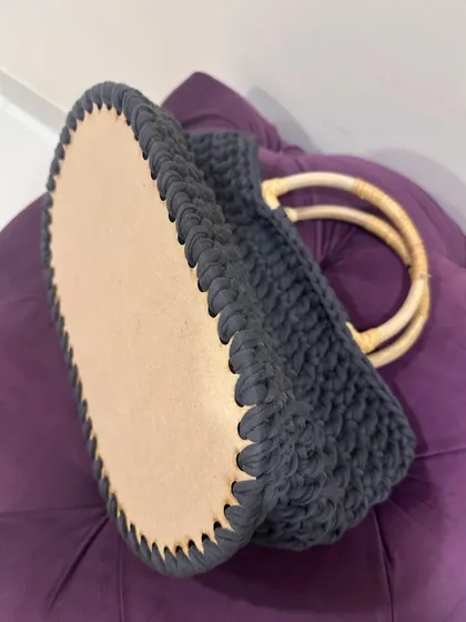 A close-up of the wooden base of the T-shirt yarn bag, showing how the first row of stitches is created.