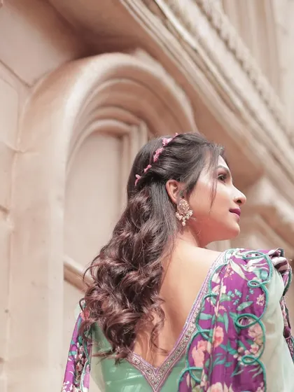 The back view of the turquoise blue lehenga with its modern peplum blouse and beautifully printed cut-work dupatta.