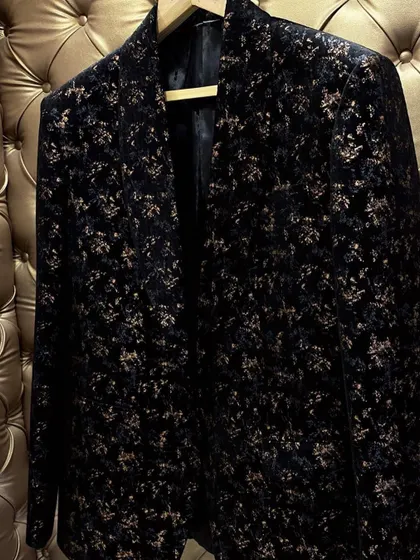 A luxurious black velvet blazer with a subtle gold floral pattern. This is a high-end party wear option that I can custom make.