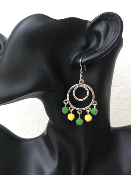 These geometric hoop earrings feature little green and yellow beaded drops for a pop of colour. The colours are fully customisable to match your style.