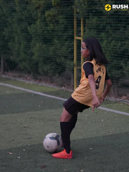 A female player practices her ball control and dribbling.