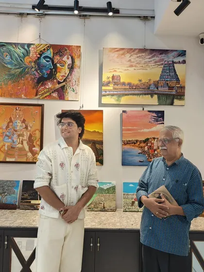 Curator Sarthak and art connoisseur Sridhar Comaravalli admire the collection of spiritual and landscape paintings at the "Vernissage" show.