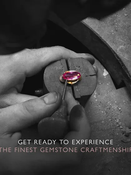 Get ready to experience the finest gemstone craftsmanship. An artisan carefully places a ruby into its setting, a moment where design and material meet to create something beautiful.