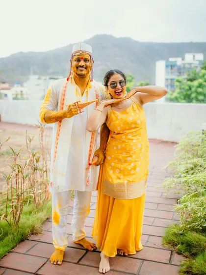A fun and playful portrait of the groom and a family member during the Haldi celebrations.