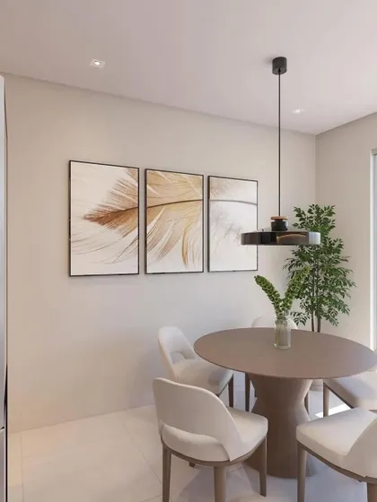 The dining area adjacent to the rendered kitchen, featuring a simple round table and modern art.