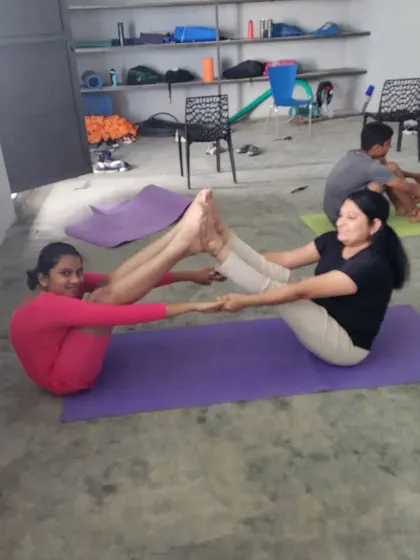 Another example of a coach and camper working together on the partner boat pose.