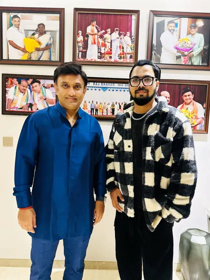 Another picture with Dr. Sudhakar in his office, surrounded by photos of his own achievements. It was an honor to be invited to perform for him and his guests.