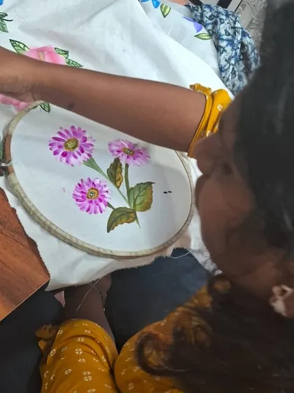 From this angle, you can see how the artist's vision comes to life, stroke by stroke. We teach techniques for blending colors and creating depth in your fabric paintings.