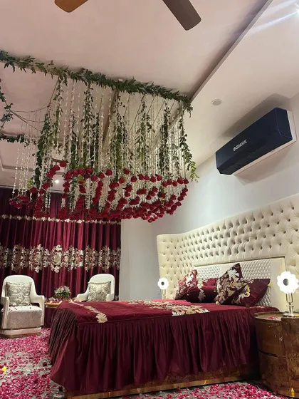 A wide shot of the fully decorated bedroom, showing the bed, the seating area, and the stunning ceiling and floor decorations.