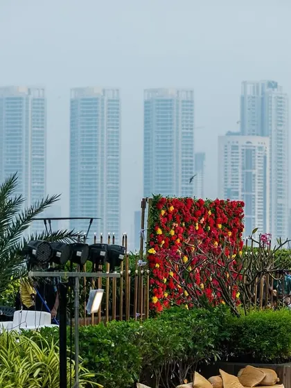 The vibrant red and yellow floral wall seen from a distance, showcasing how our decor can transform a venue and stand out against the urban landscape.