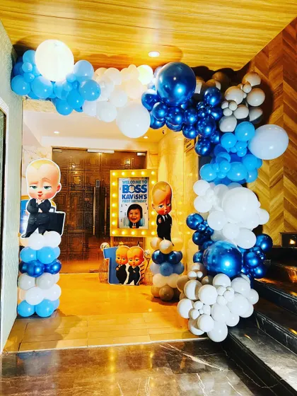 The entrance decor for the "Boss Baby" party, with a full balloon arch in shades of blue and white leading guests to the celebration.