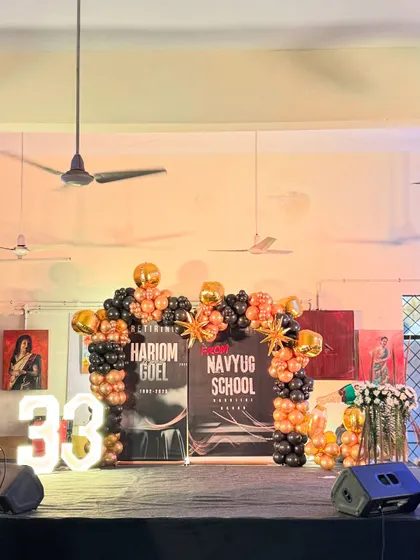 A full view of the retirement party stage, including a light-up marquee number '33' to signify years of service.