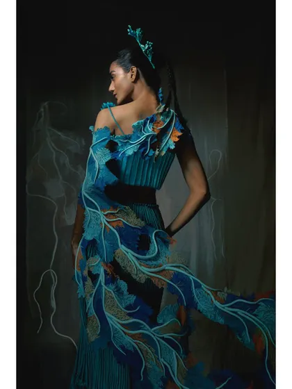 The back of a stunning blue, feather-like gown from the Vaishali S campaign. The hand-drawn lines on the backdrop were part of the set design, adding another layer of artistry.