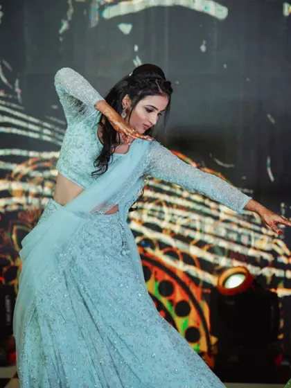 A professional dancer performing a choreographed piece at a Sangeeth. I work with top artists to create performances that align with your event's theme and story.