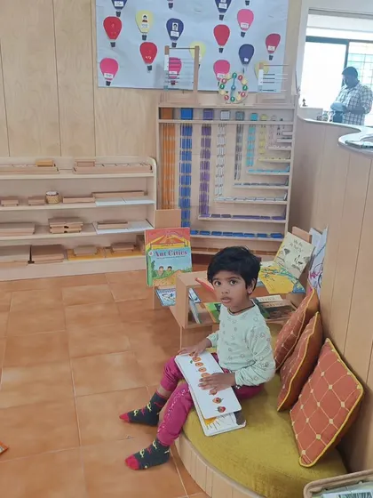 A quiet moment in our reading nook. Providing comfortable and inviting spaces for reading encourages children to pick up a book and explore new worlds independently.