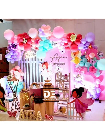 A side view of Ayra's fairy party setup, highlighting the layered design and the mix of different textures and colors in the balloon garland.