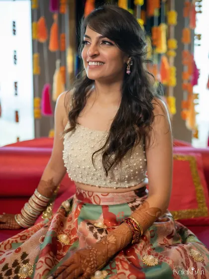 A candid portrait of a bride, smiling happily during one of her pre-wedding events. Her natural joy is what makes this photo beautiful.