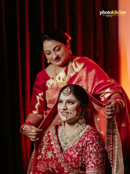 A beautiful portrait of a bride being blessed by her mother, a timeless moment captured in a traditional Indian wedding setting.