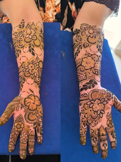 A designer Sudani-style floral mehendi. This style is known for its bold, dark lines and striking flower patterns.