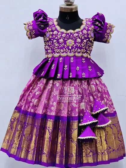 A variation of the purple and lime green design, this one features a pink Banarasi skirt. The purple peplum blouse has intricate gold and pearl embroidery.