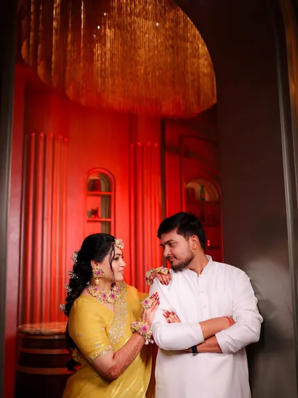 A dramatic and beautifully lit couple portrait from the haldi function.